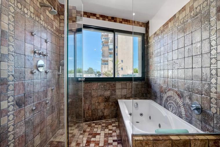 Baño suite con bañera de hidromasaje y ducha lluvia